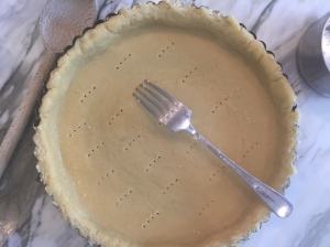Using a fork, prick all over the bottom of the tart.