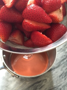 Using a sieve, strain the strawberries over a small saucepan to catch any juice they've released.