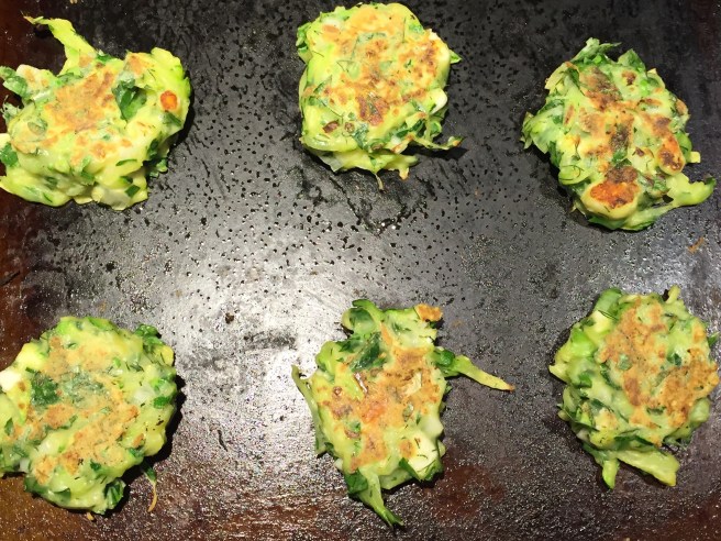 zucchini fritters are cooking on the other side