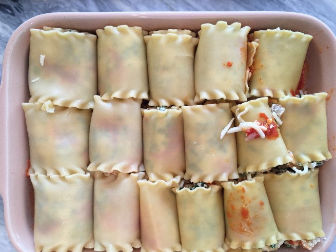 Lasagna roll ups fit snugly in the casserole dish.