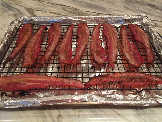 Cooked bacon on foiled lined sheet pan.