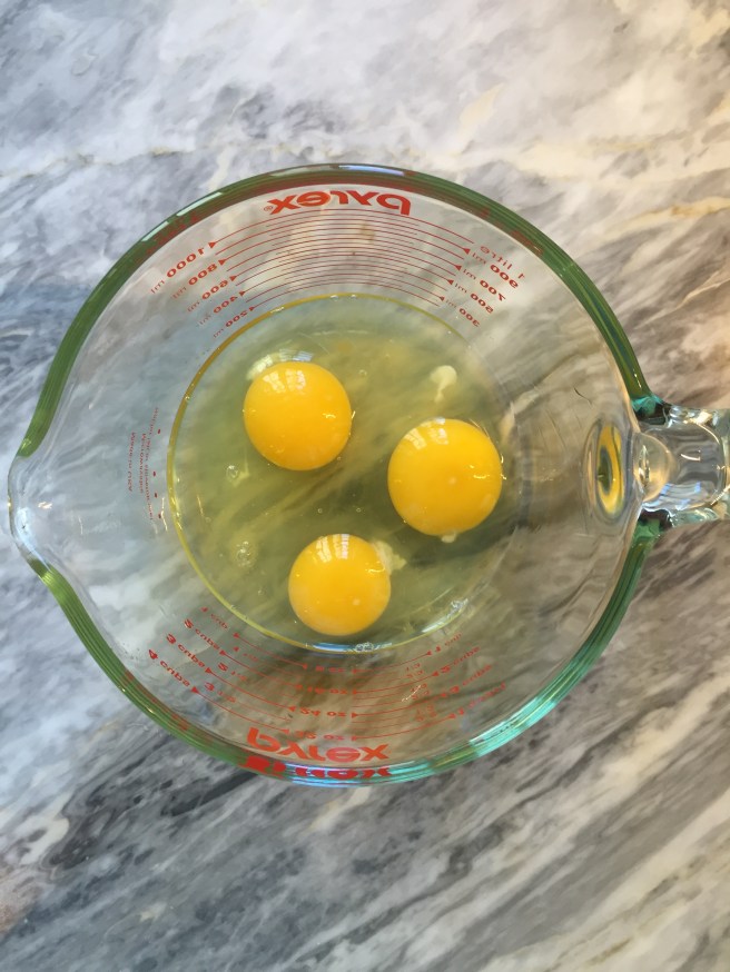3 eggs ready for whisking.