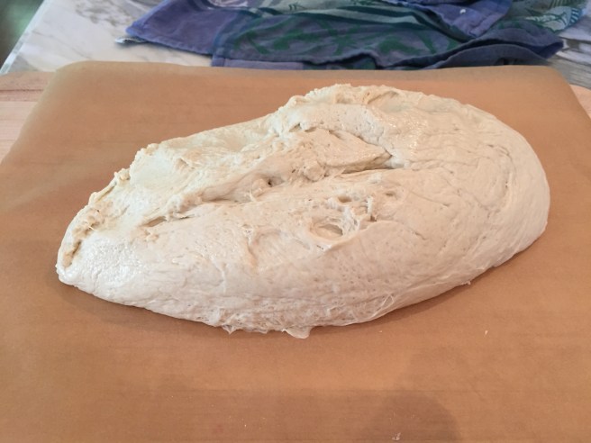 Pretzel dough on a cutting board.
