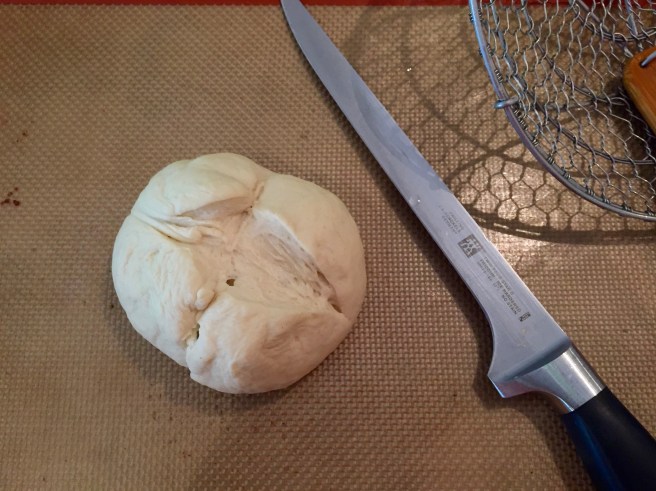 Use a sharp knife to cut an 'x' on the top of each bun.