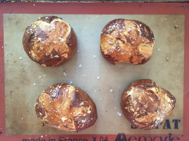 Deep golden brown homemade pretzel buns.