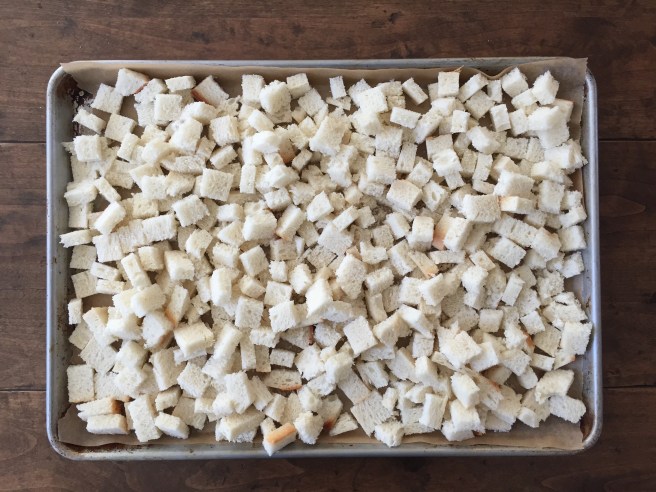 Drying bread cubes on sheet pan.
