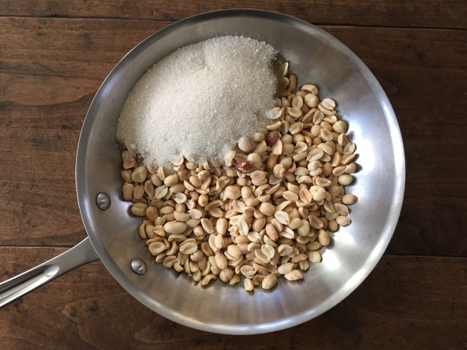 Peanuts, sugar, and water in skillet