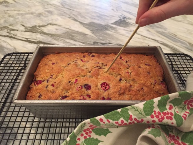Testing the bread for doneness with a bamboo skewer.