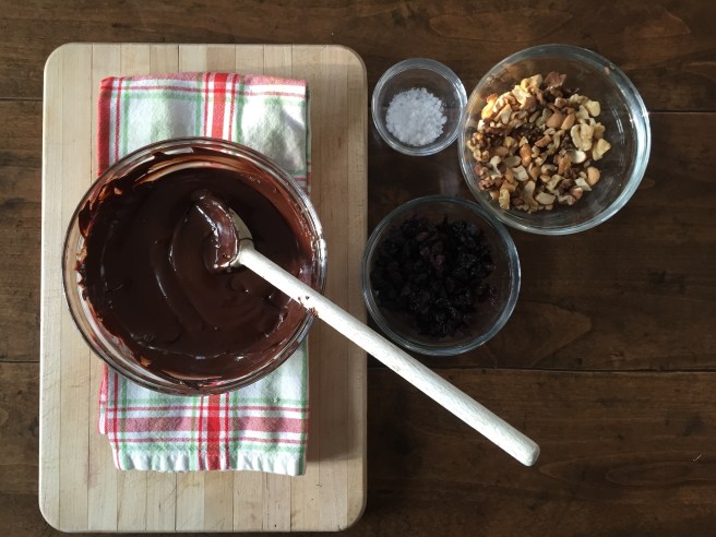 Melted chocolate in bowl waiting for toasted nuts and dried fruit to be added.