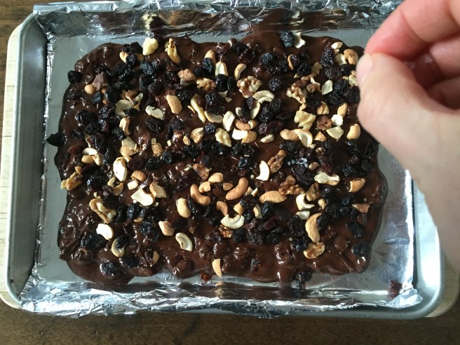 Sprinkling flaky sea salt on top of chocolate bark.