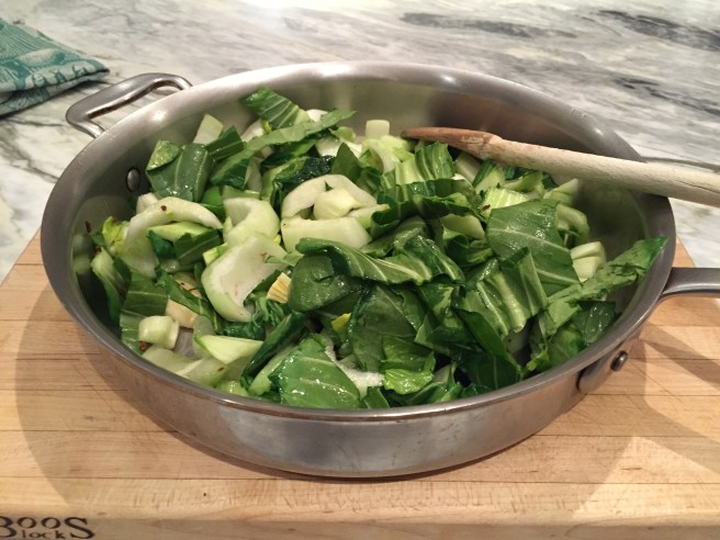 Stir the bok choy, giving it a light coat of the flavored oil.