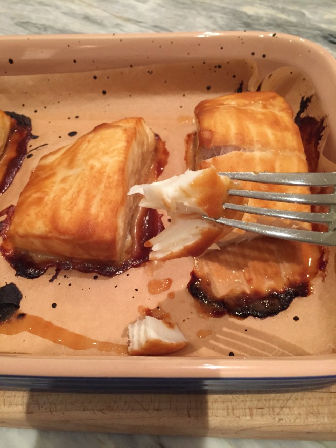 Checking fish for doneness, opaque and easily flakes with a fork.