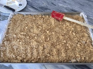 Crumbly flour mixture in foil lined sheet pan