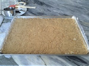 Crumbly dough patted down evenly throughout sheet pan.