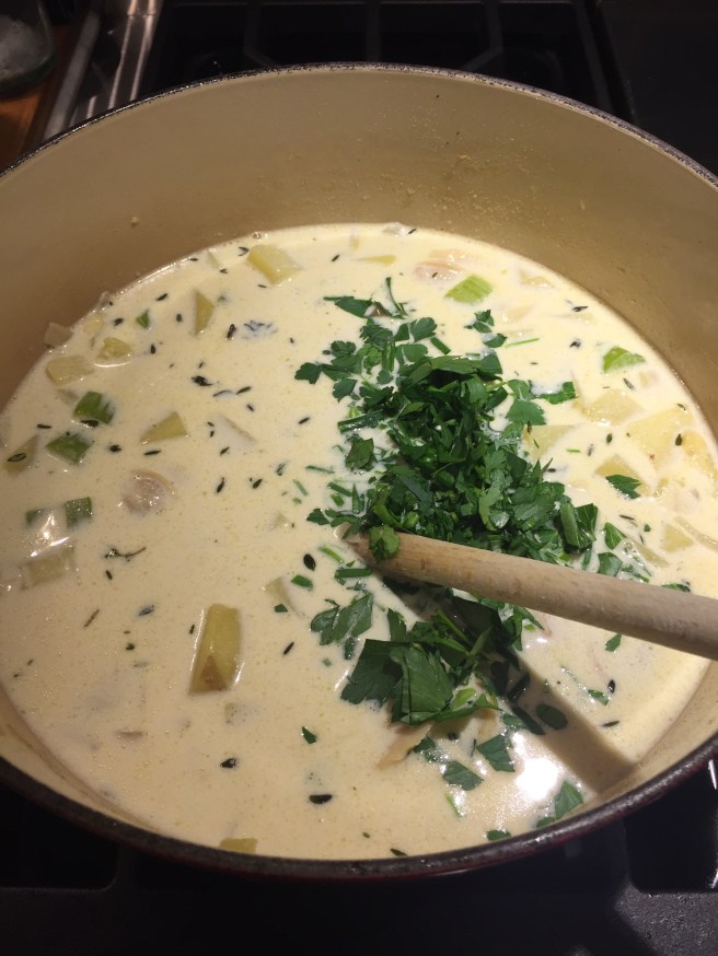 Stirring in parsley and chives