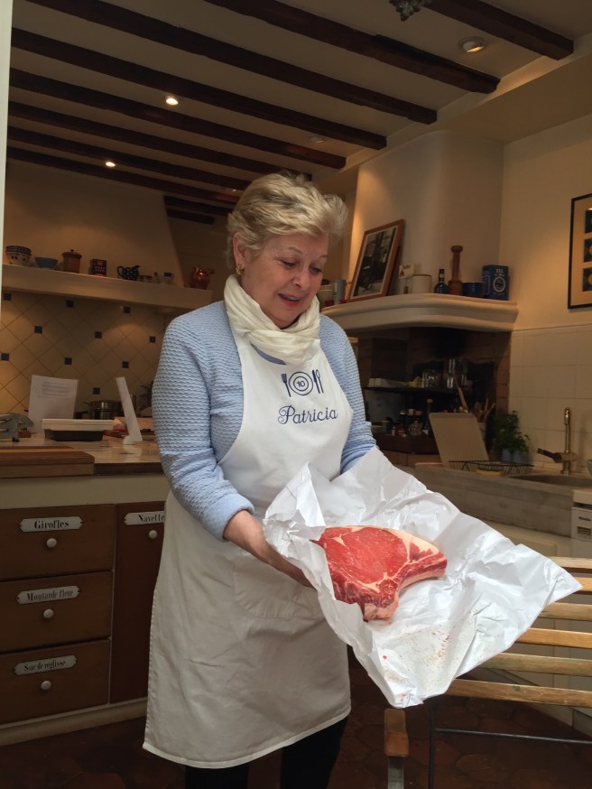 Patricia Wells holding a rib-eye